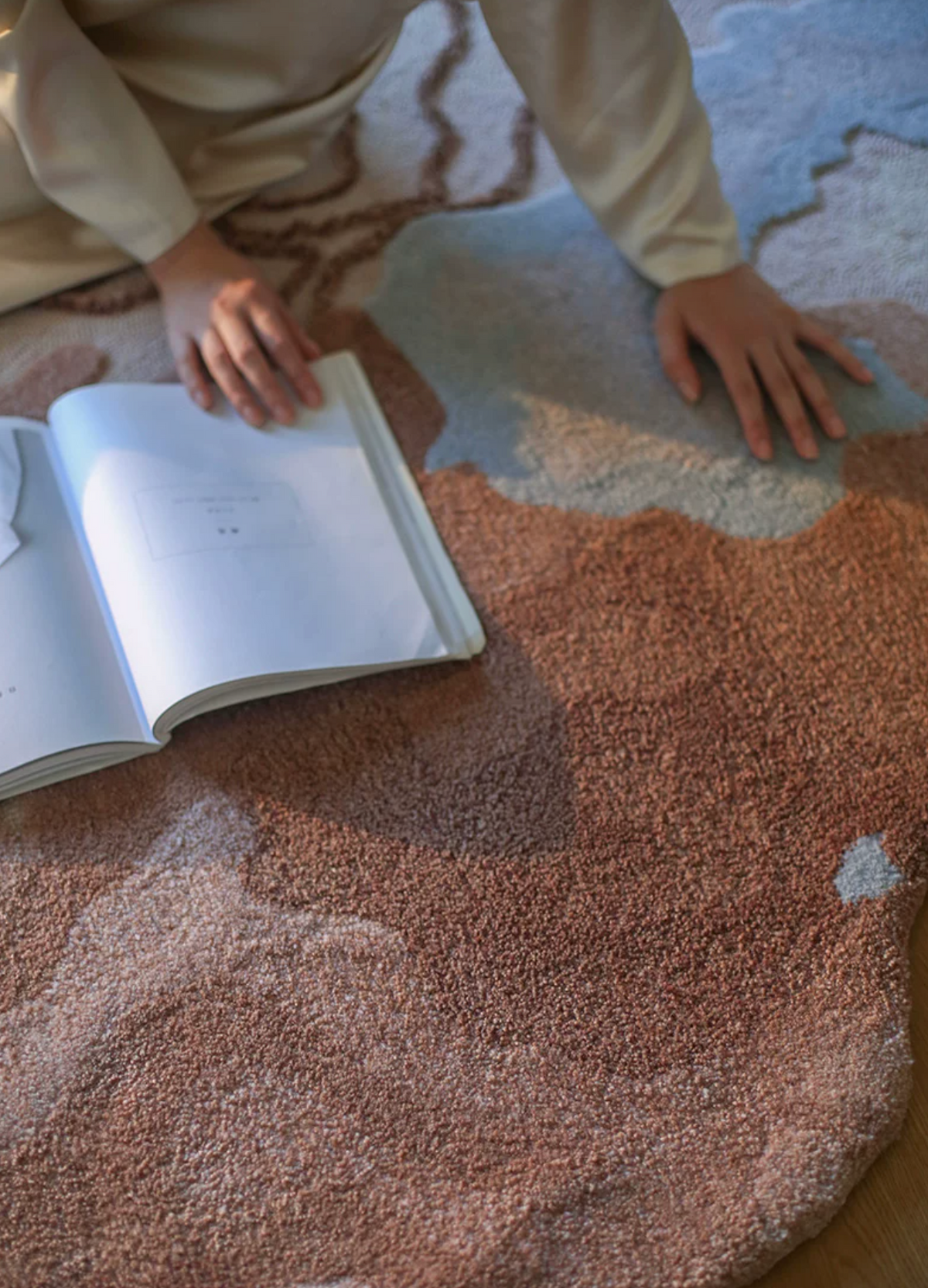 Hewn Earth Studio Delta rug featuring textured, natural fiber design with geometric patterns on a neutral background.