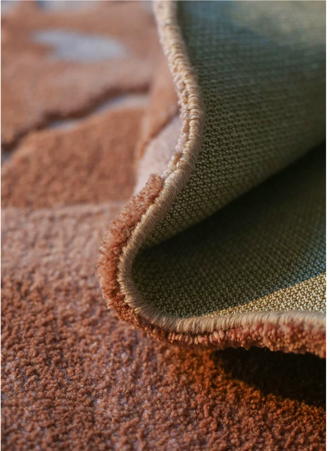 Handwoven Delta rug by Hewn Earth Studio featuring intricate patterns and natural fibers, showcased in a close-up image.