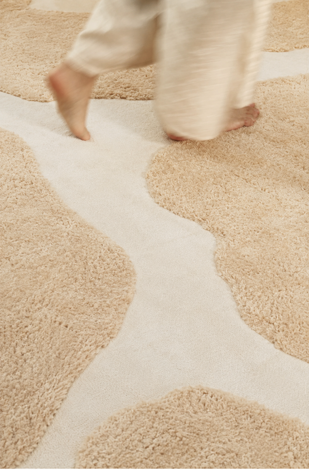 Hewn Earth Studio Bloom rug featuring a dune-flora lie pattern with earthy tones and intricate botanical design.