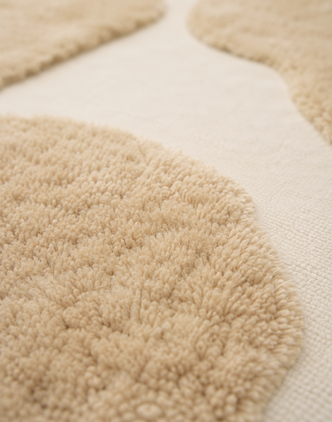 Hewn Earth Studio Bloom rug with dune-flora pattern, showcasing soft, textured textile design in natural earthy tones.