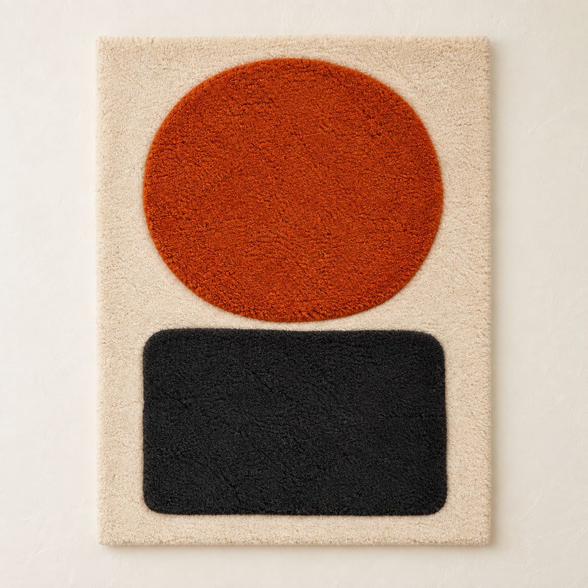 Hewn Earth wall art featuring an Ember Disc with a charcoal plinth, showcasing modern, textured ceramic design.