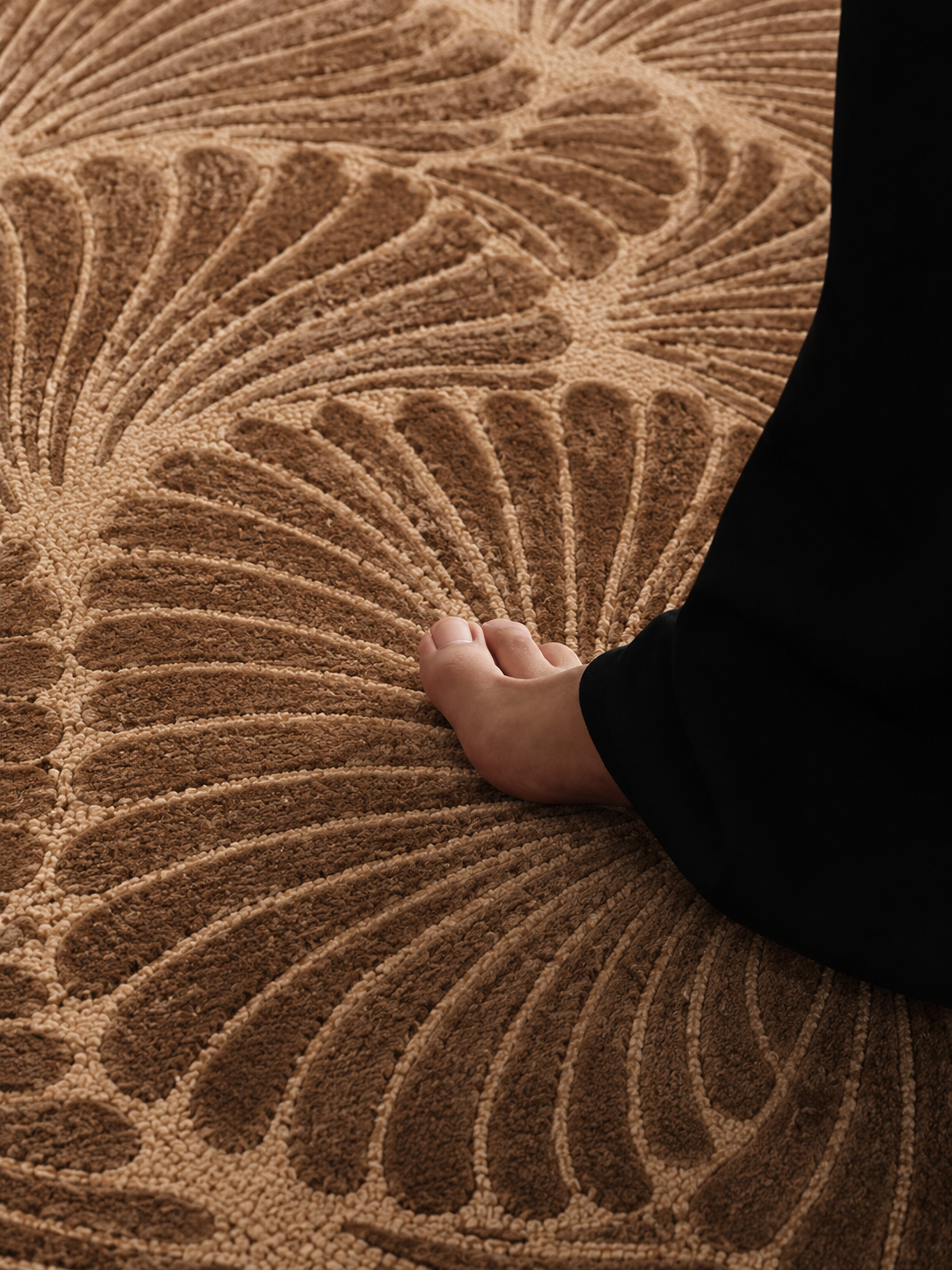 Hewn Earth Studio Frond rug featuring a detailed natural leaf design on a neutral background, suitable for bohemian or modern decor.