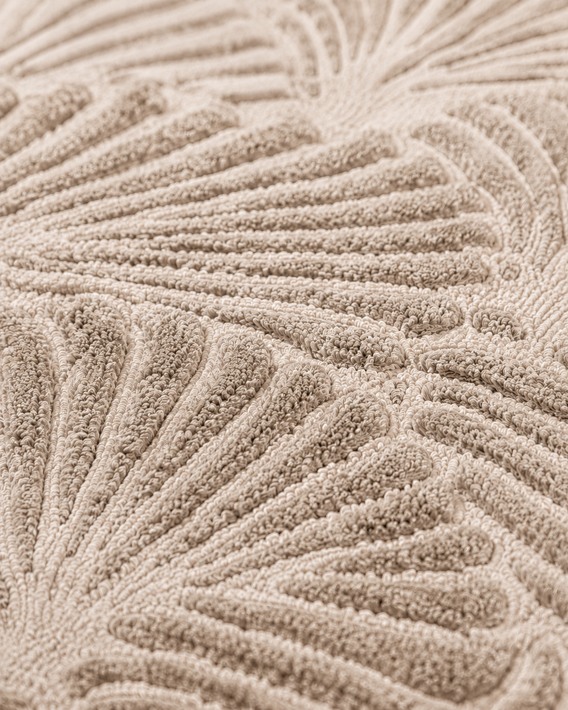 Hewn Earth Studio Frond rug with a woven oat-colored pattern, showcasing textured natural fiber design for cozy home decor.
