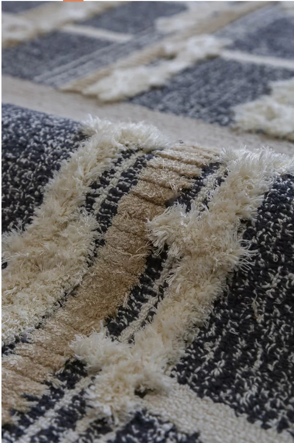 Hewn Earth Studio grid rug with a geometric pattern, showcasing a close-up view of the textured, modern design.