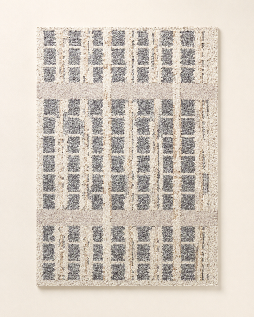 Hewn Earth Studio grid rug with geometric pattern in neutral tones, showcasing textured woven fabric on a neutral background.
