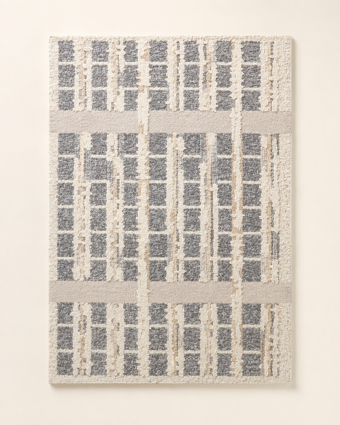 Hewn Earth Studio grid rug with geometric pattern in neutral tones, showcasing textured woven fabric on a neutral background.