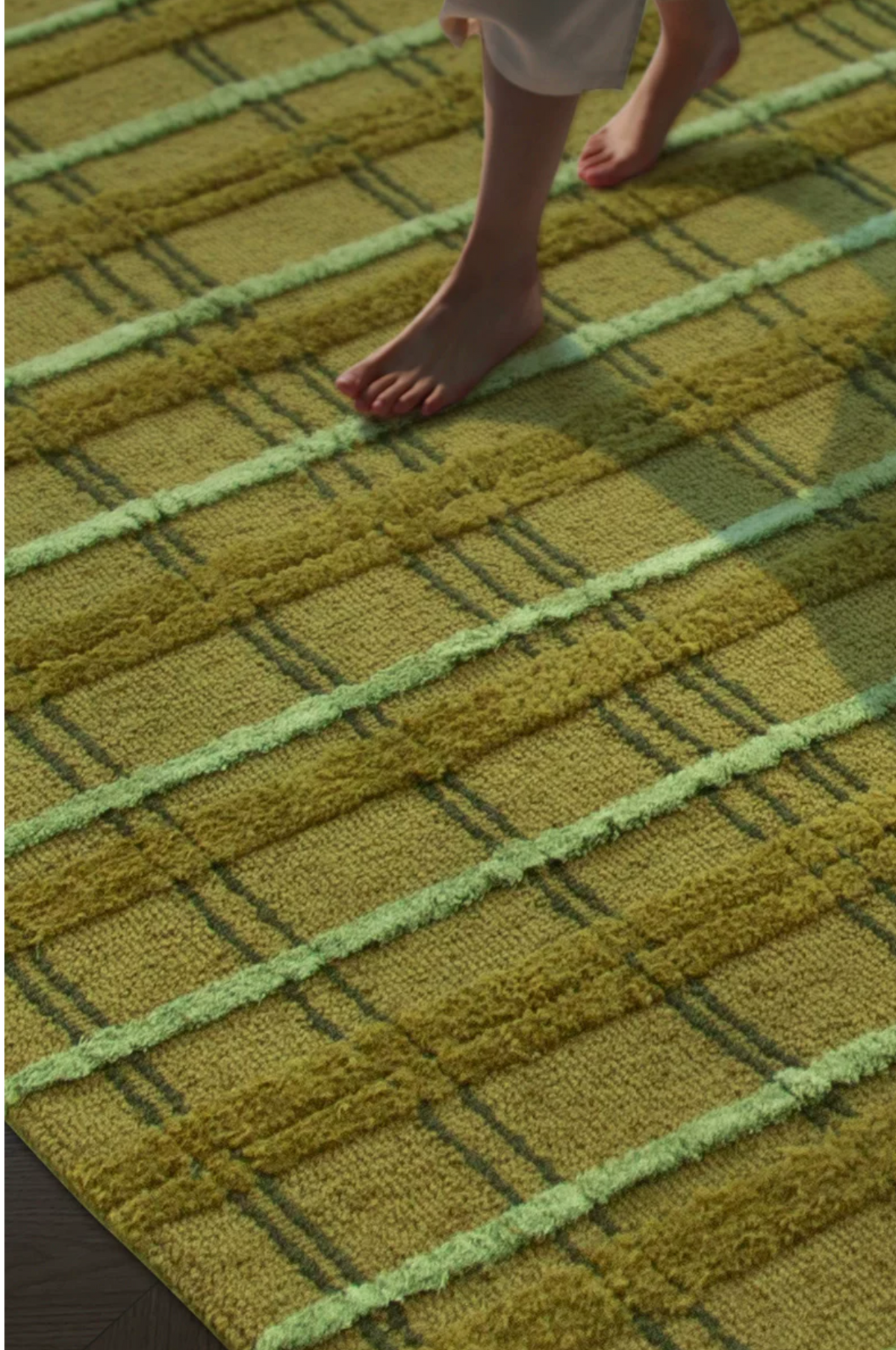 Hewn Earth Studio moss handwoven grid rug with textured moss green pattern, natural fiber design for cozy home decor.