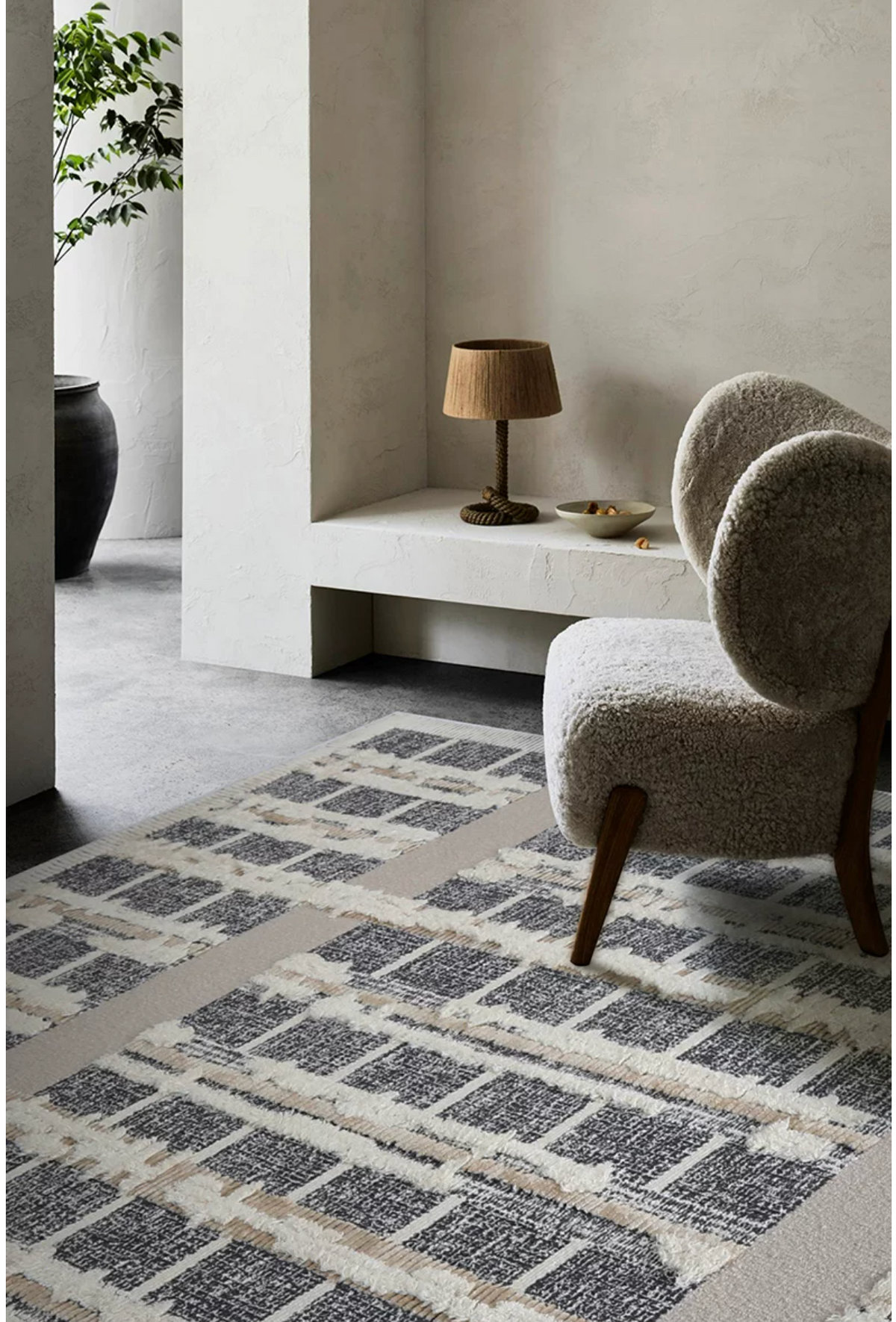 Hewn Earth Studio grid rug with geometric pattern, textured fabric, and neutral tones, suitable for contemporary living room decor.