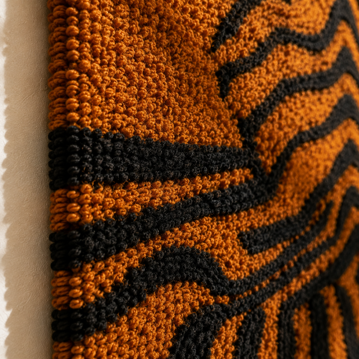Close-up of Hewn Earth Ochre Tiger Lines wall art featuring bold ochre and black tiger stripe patterns on textured surface.