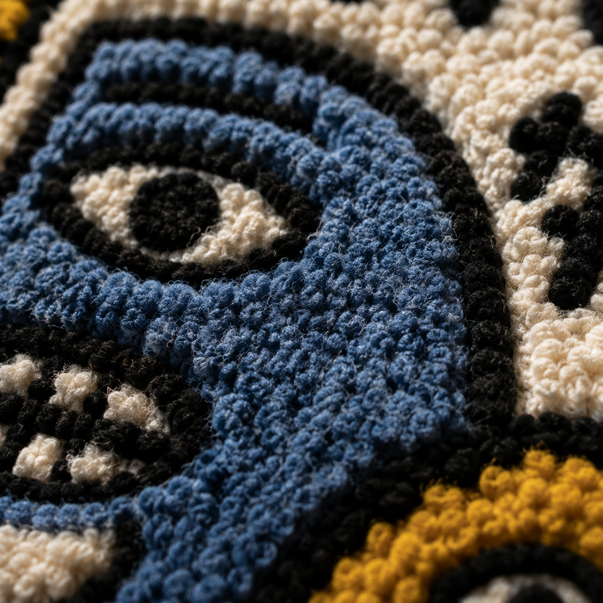 Close-up of Hewn Earth Midnight City Faces wall art showing detailed urban face illustrations on textured surface.