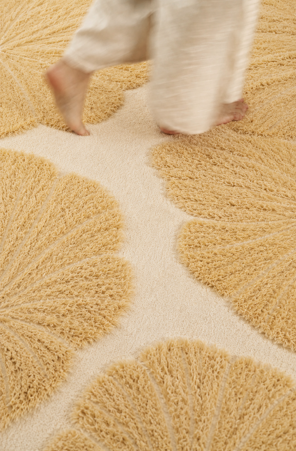 Close-up of a Hewn Earth Studio Lily rug featuring intricate floral patterns and soft, natural fibers.