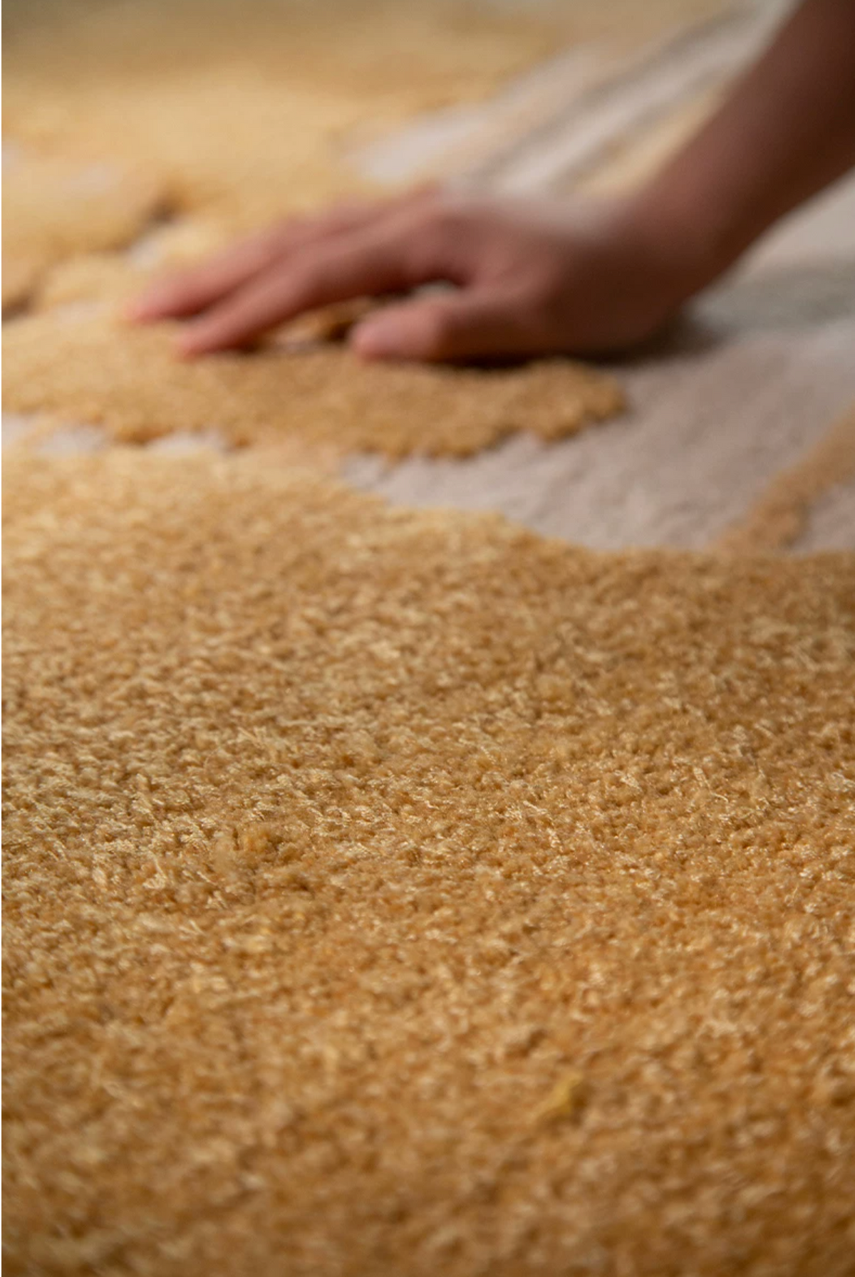 Hewn Earth Studio Lode rug displayed on a stand, showcasing its textured woven design and earthy color palette.