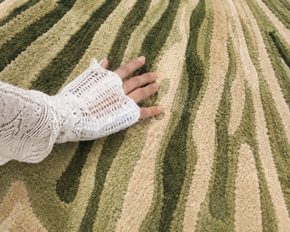 Hewn Earth Studio Lotus hand-woven rug featuring intricate lotus flower design in neutral tones.