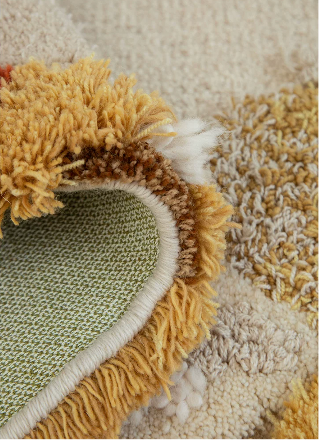 Hewn Earth Studio Meadow autumn rug with earthy tones, back view showing textured woven design and soft fabric edges.