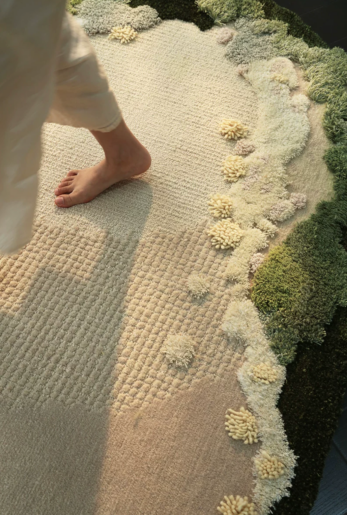 Hewn Earth Studio Meadow hand-woven rug with intricate patterns and natural earthy tones, shown in a close-up image.