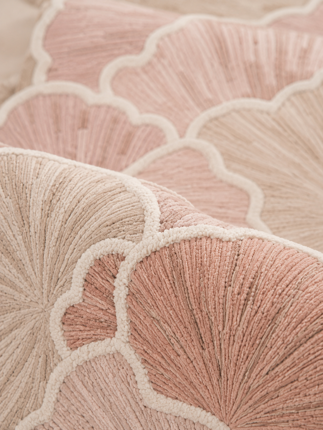 Hewn Earth Studio Petal blush hand-woven rug with soft, textured floral design on neutral background.