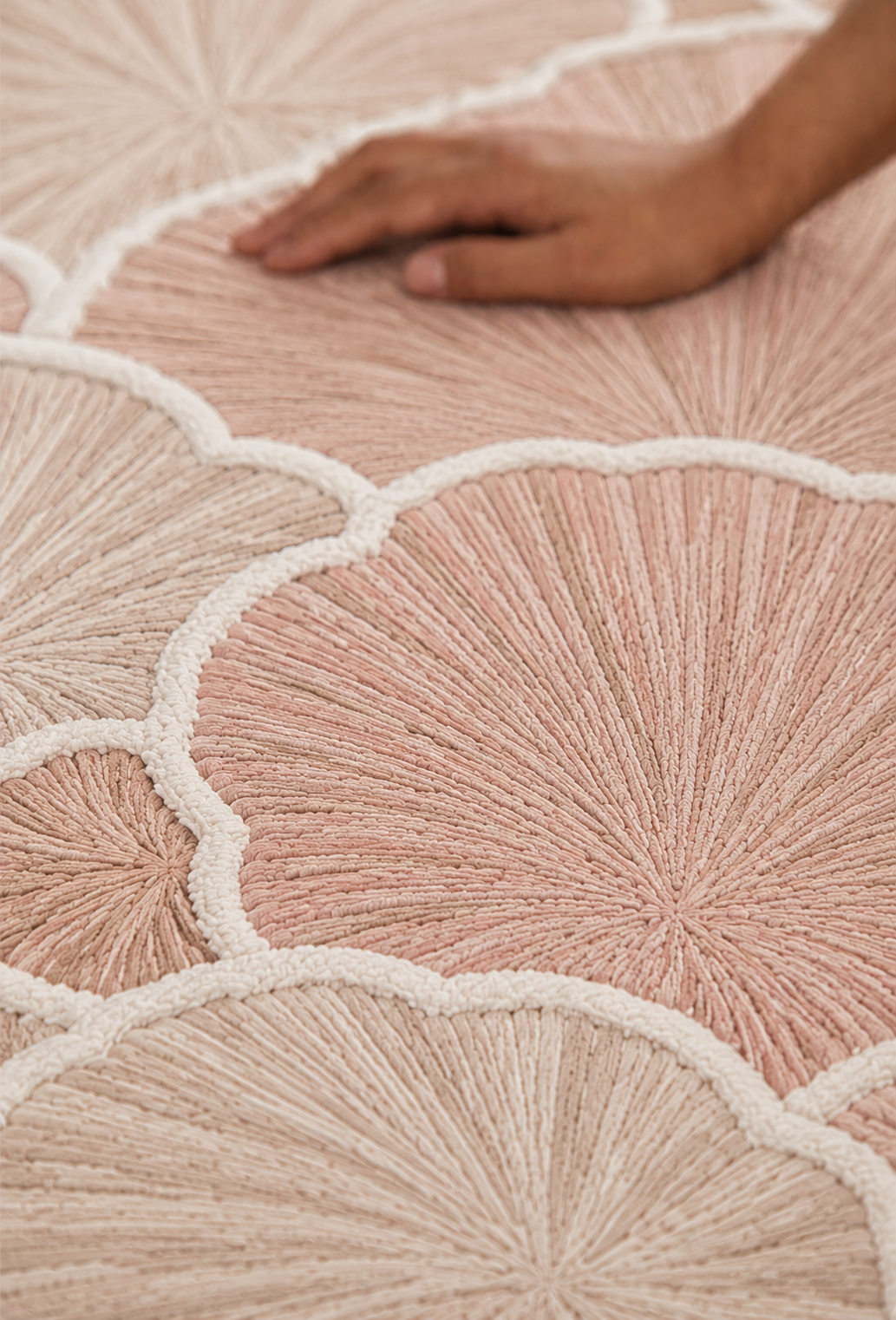 Hewn Earth Studio Petal blush rug with handcrafted floral design, soft texture, and intricate pattern for cozy home decor.