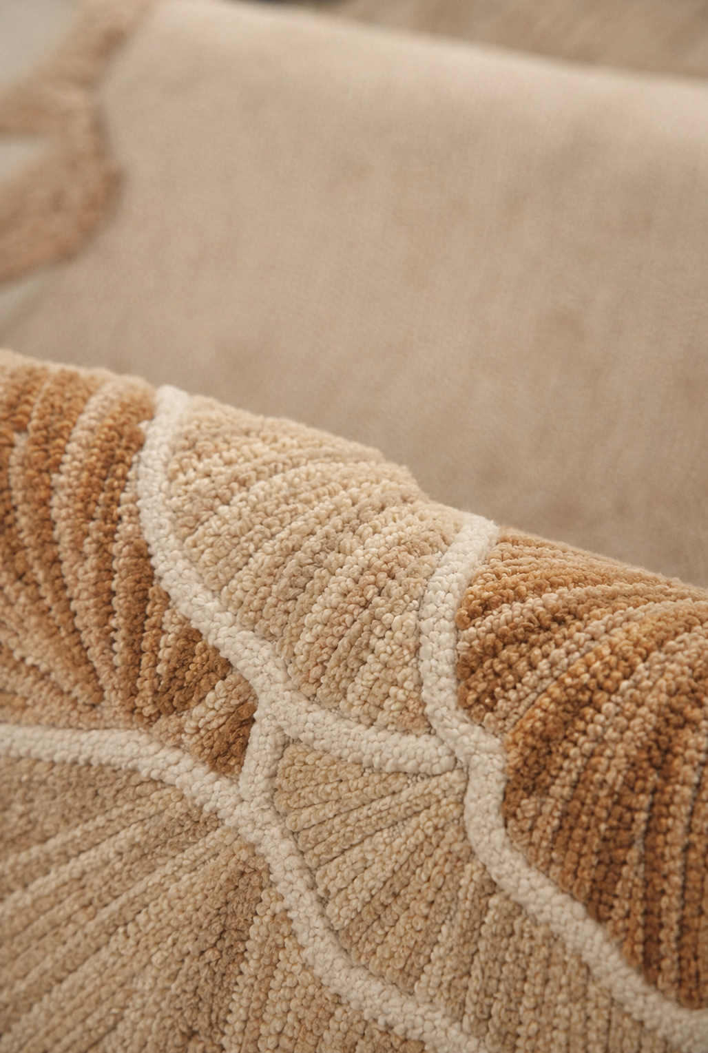 Hewn Earth Studio Petal rug featuring soft, textured petal-shaped design in natural tones, perfect for cozy living spaces.