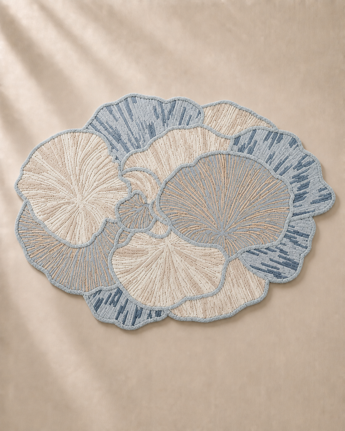 Hewn Earth Studio Petal rug featuring a soft mist-colored floral-inspired design on a cozy, textured textile surface.