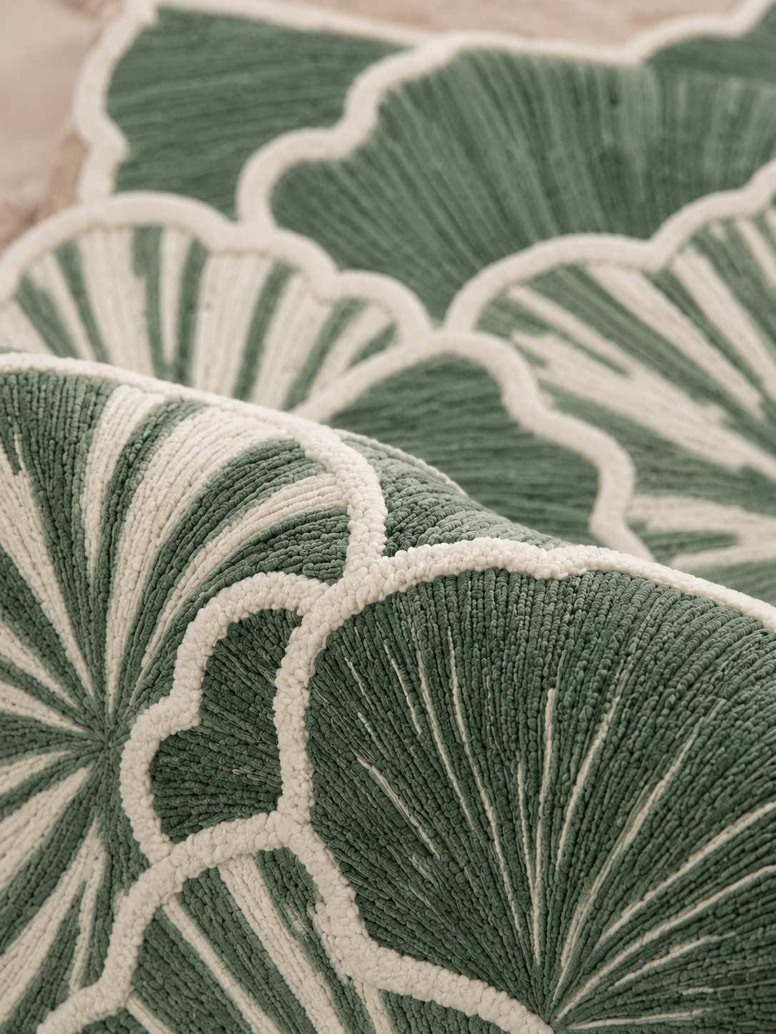 Close-up of Hewn Earth Studio's Petal sage rug featuring intricate floral patterns and soft woven texture.
