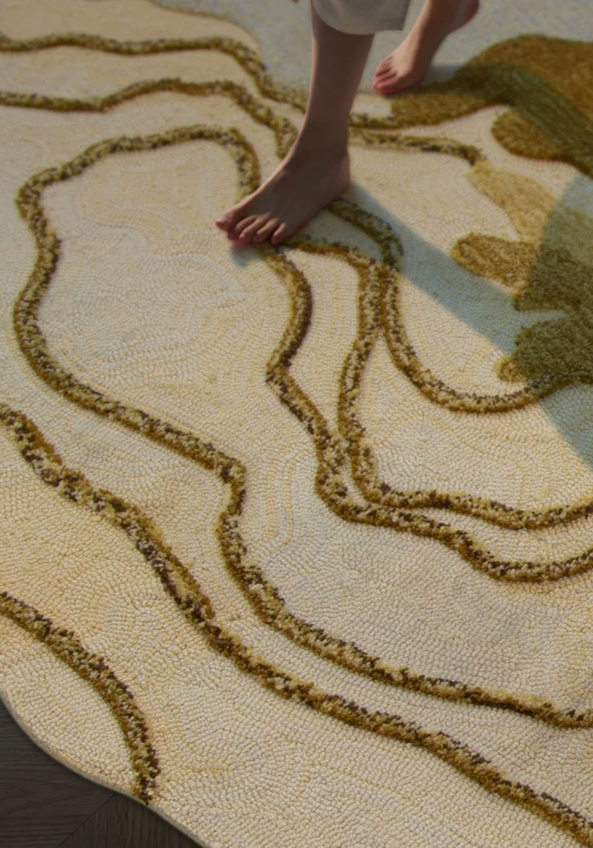 Close-up of Hewn Earth Studio's Strata gold rug showcasing intricate woven pattern and rich texture.