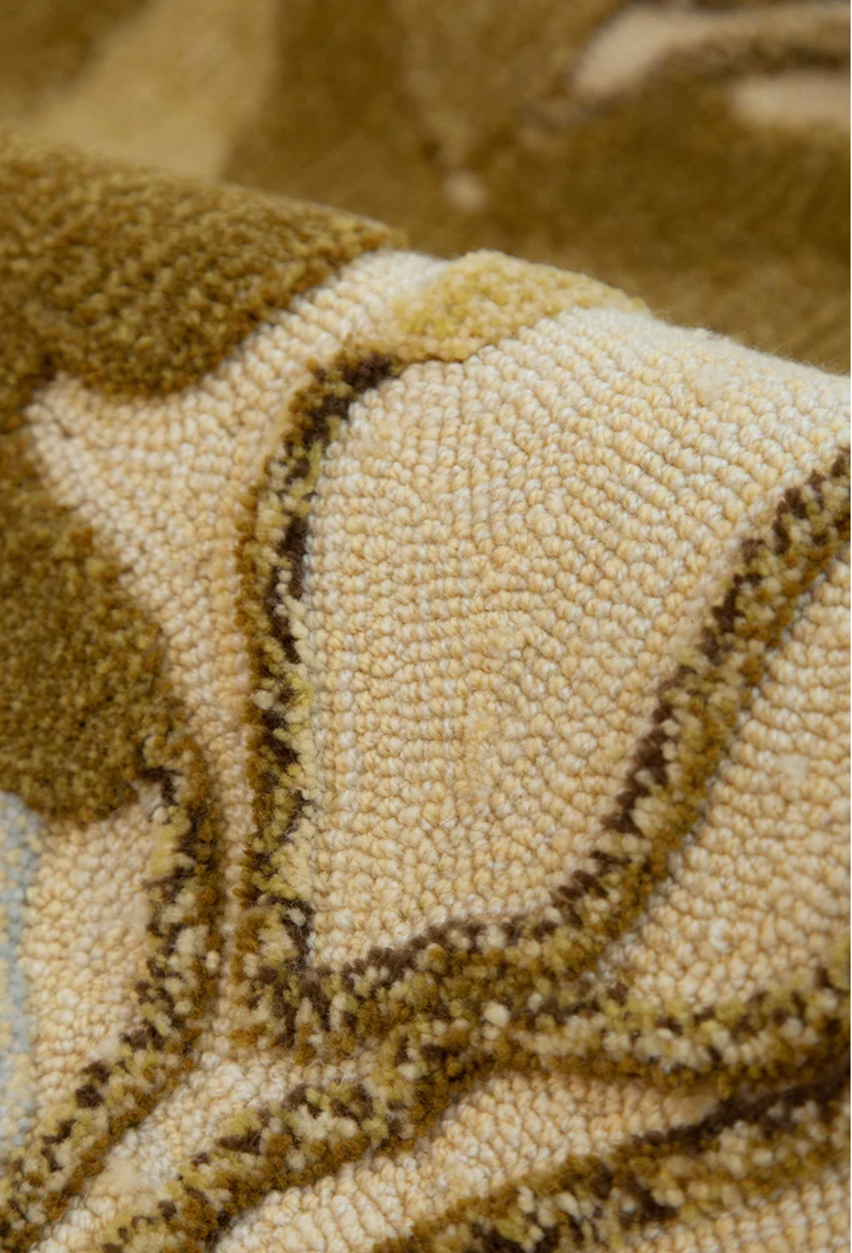 Hewn Earth Studio Strata gold rug featuring a textured, layered design in warm gold tones, suitable for modern interior decor.