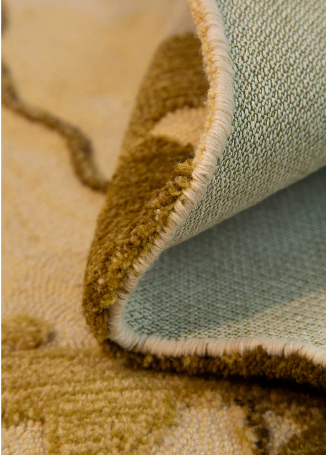 Hewn Earth Studio Strata gold rug with intricate pattern, soft texture, and vibrant gold tones, ideal for modern living room decor.