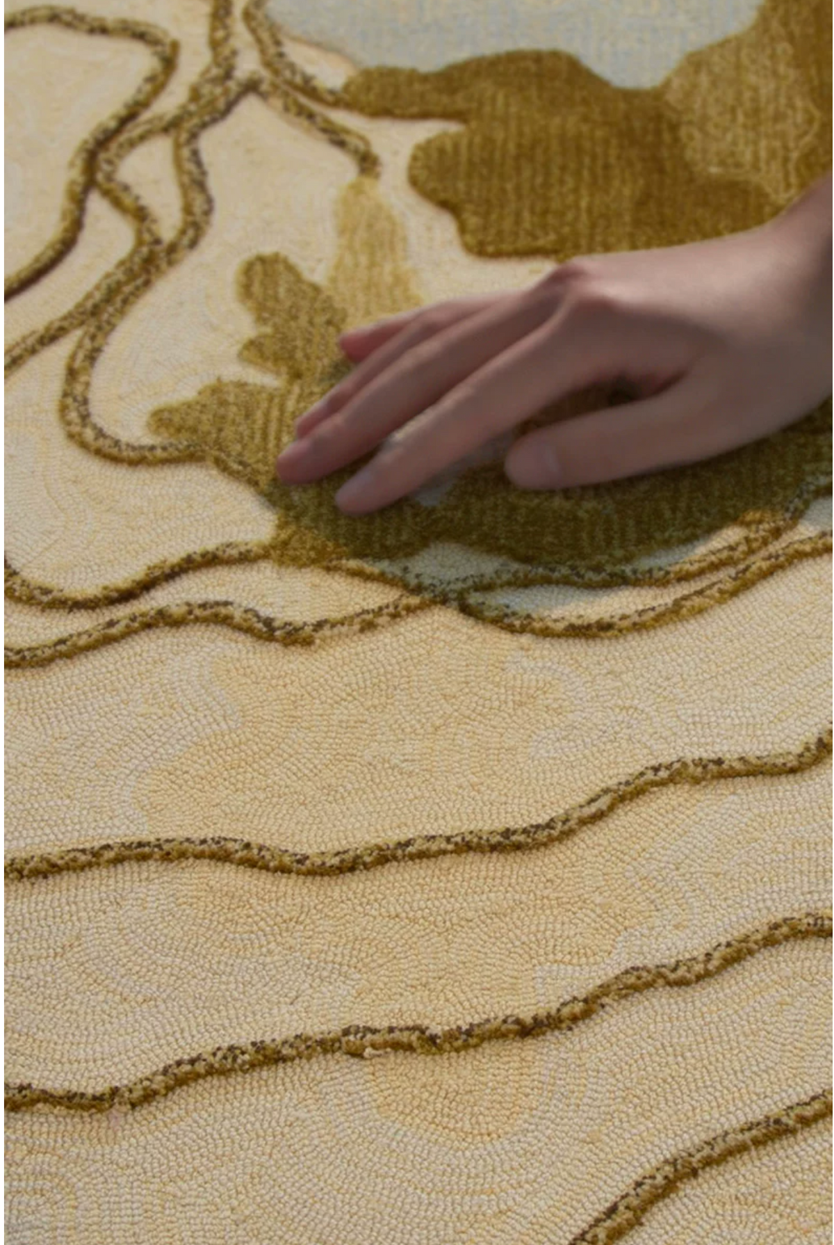Hewn Earth Studio Strata gold rug with intricate geometric pattern displayed in a modern room setting