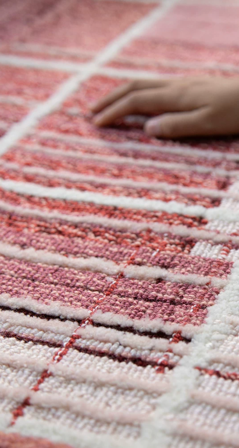 Close-up of Hewn Earth Studio woven rug weft showing detailed fiber texture and rich colors in a macro shot.